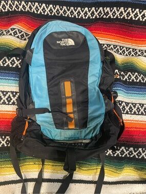 The North Face Men’s “Hot Shot” Blue and Black Backpack with Orange Accents